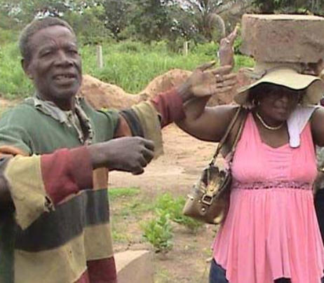 old man with the old lady carrying stone